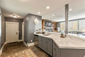 Interior space featuring vanity, a textured ceiling, and tile floors