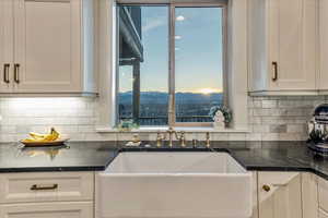 Kitchen featuring white cabinets, a mountain view, and tasteful backsplash