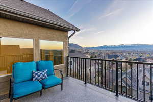 Balcony at dusk featuring a mountain view