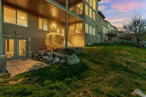 Yard at dusk featuring a patio area