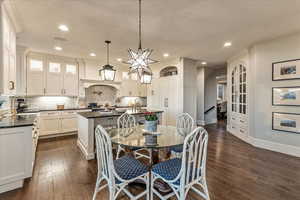 Dining room featuring a textured ceiling, engineered hardwood flooring, and sink