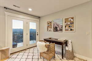 Dining space with plenty of natural light, french doors, and a mountain view