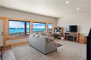 Living room with a water view and LVP and carpet flooring