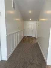 Corridor with dark colored carpet