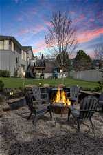 Yard at dusk featuring a fire pit and a wooden deck
