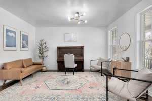 Living room featuring an inviting chandelier and light hardwood / wood-style floors