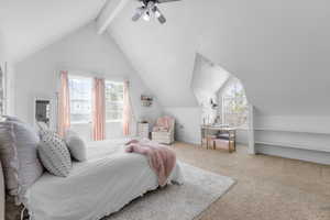 Bedroom featuring lofted ceiling with beams, light colored carpet, and ceiling fan