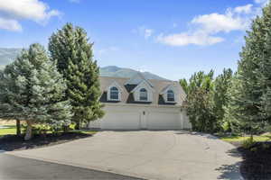 View of front facade with a mountain view and a garage