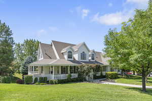 View of front facade with a porch and a front yard