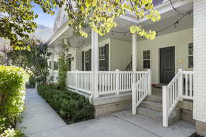 Entrance to property with covered porch and a mountain view