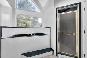 Bathroom featuring lofted ceiling, tile flooring, and independent shower and bath