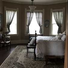 Bedroom with dark hardwood / wood-style flooring and crown molding