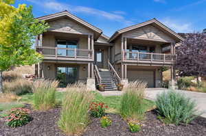 View of front of home with a balcony and a garage