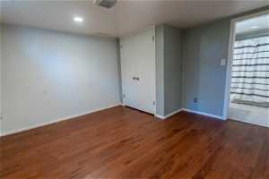 Empty room with dark wood-type flooring