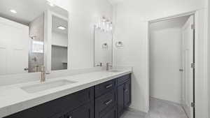 Bathroom featuring tile flooring, double sink, and large vanity