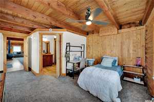 Bedroom with carpet, beamed ceiling, and wooden ceiling