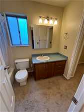 Full bathroom featuring shower / tub combo, vanity, toilet, and a textured ceiling