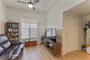 Unit 1004 - Living room featuring light hardwood / wood-style floors and ceiling fan