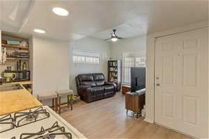 Unit 1004 - Bedroom with ceiling fan, light hardwood / wood-style flooring, a textured ceiling, and sink
