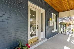 Doorway to property featuring a porch