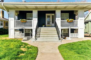 View of front of home with a porch and a front yard