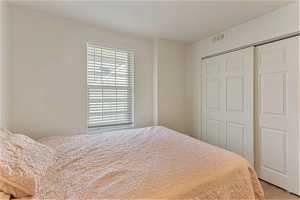 Unit 1004 - Bedroom with a closet and light hardwood / wood-style flooring