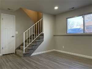 Staircase with dark hardwood / wood-style flooring