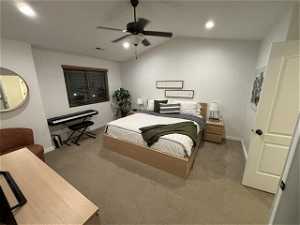 Bedroom featuring lofted ceiling, ceiling fan, and carpet flooring