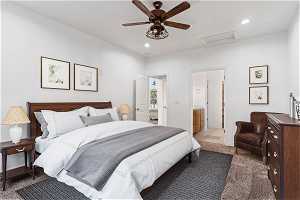 Bedroom with dark colored carpet, connected bathroom, and ceiling fan