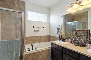 Primary Bathroom featuring double sink vanity and plus walk in shower