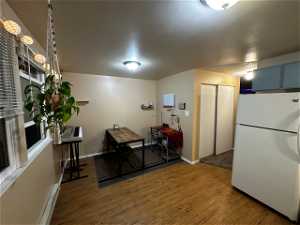 Interior space featuring hardwood / wood-style flooring and white fridge