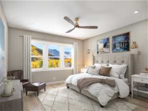 Bedroom with ceiling fan and light hardwood / wood-style floors