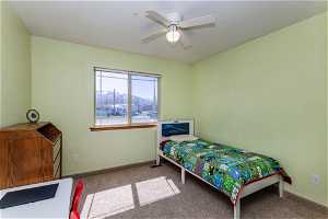 Bedroom with light colored carpet and ceiling fan. 2 of 3 on the main floor if 5 total.