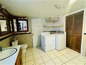 Combined room for washer & dryer and full bath