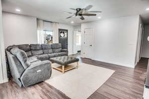 Living room featuring hardwood / wood-style flooring and ceiling fan