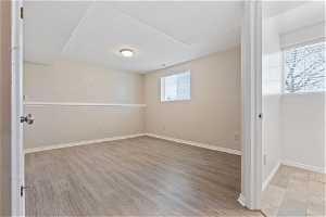 Spare room with a healthy amount of sunlight and light hardwood / wood-style floors