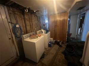Basement featuring wood walls and separate washer and dryer