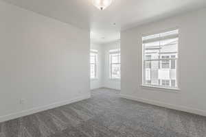 Carpeted spare room featuring a textured ceiling