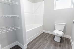 Bathroom featuring toilet and hardwood / wood-style floors