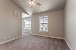 Empty room with lofted ceiling, carpet, a textured ceiling, and ceiling fan