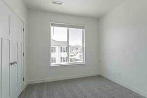 Unfurnished room featuring carpet flooring