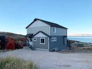 Rear view of property featuring a water view