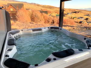 View of pool with a hot tub