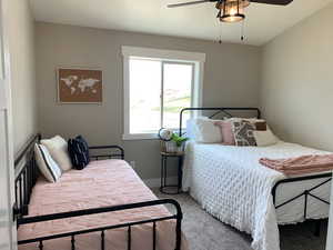 Bedroom with ceiling fan and carpet flooring