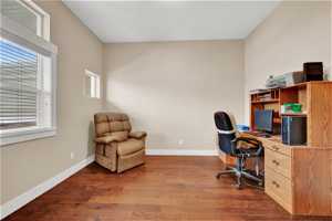 Home office with hardwood flooring