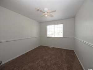 Upstairs  carpeted bedroom featuring ceiling fan