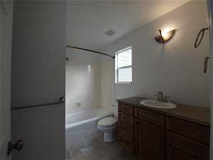 Upstairs  full primary bathroom with tile floors, tub / shower combination, vanity, and toilet