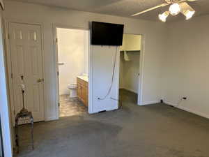 Master bedroom with  spacious walk-in closet, ceiling fan and TV