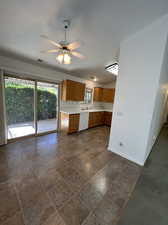 Kitchen with ceiling fan, white dishwasher, and double sink