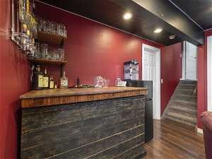 Bar featuring dark wood-type flooring